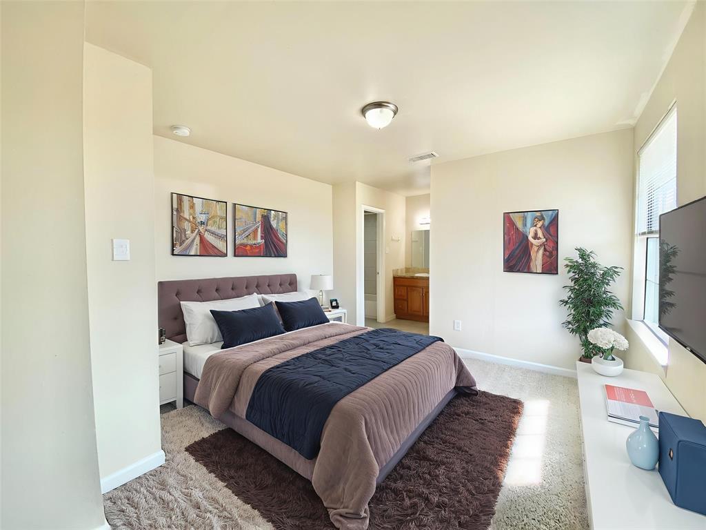 8001 C Rothington Road, Unit 21 Dallas, TX 75227 - Photo 17 of 32 a bedroom with a bed and a flat screen tv