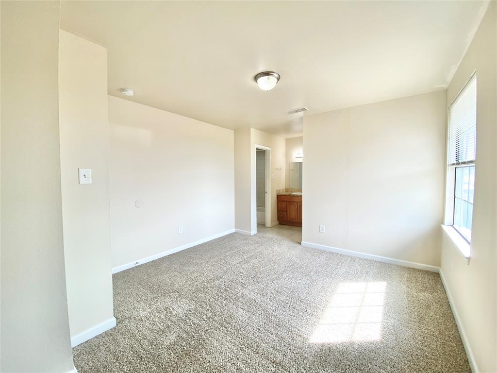 8001 C Rothington Road, Unit 21 Dallas, TX 75227 - Photo 18 of 32 a view of an empty room and window