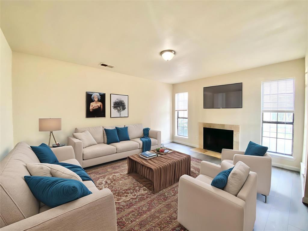 8001 C Rothington Road, Unit 21 Dallas, TX 75227 - Photo 2 of 32 a living room with furniture and a fireplace