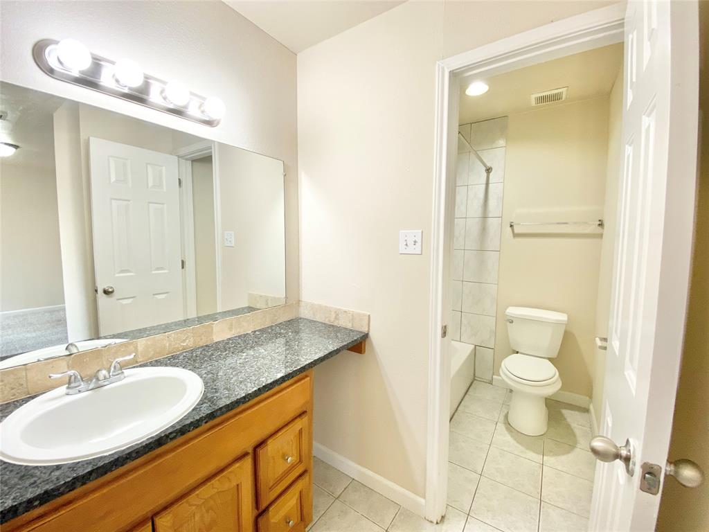 8001 C Rothington Road, Unit 21 Dallas, TX 75227 - Photo 26 of 32 a bathroom with a granite countertop sink toilet and shower