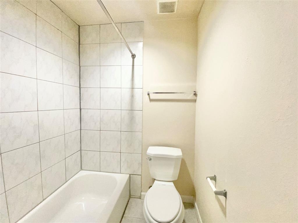 8001 C Rothington Road, Unit 21 Dallas, TX 75227 - Photo 27 of 32 a white toilet sitting next to a bath tub