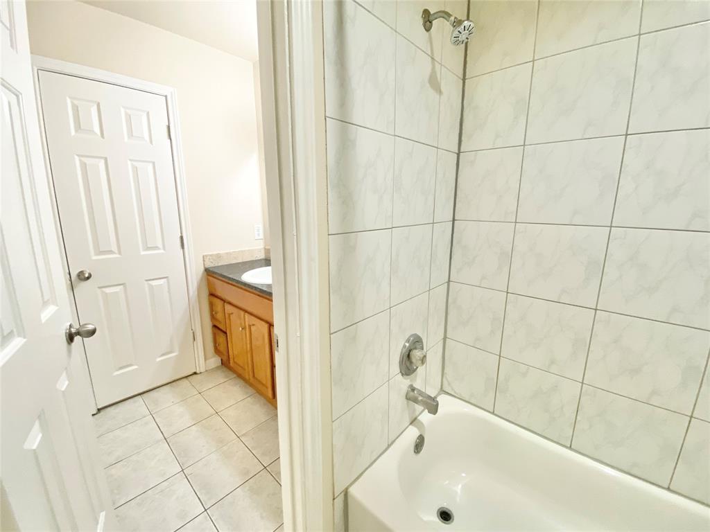 8001 C Rothington Road, Unit 21 Dallas, TX 75227 - Photo 28 of 32 a bathroom with a bathtub and a shower