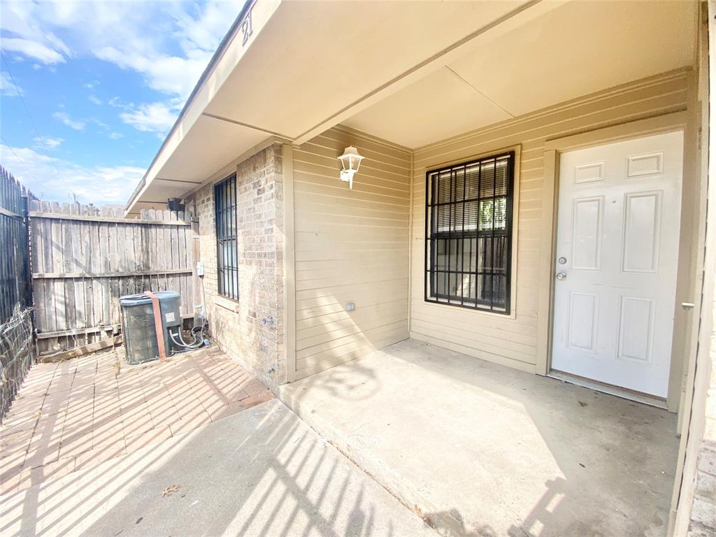 8001 C Rothington Road, Unit 21 Dallas, TX 75227 - Photo 31 of 32 a view of a balcony with wooden floor and fence