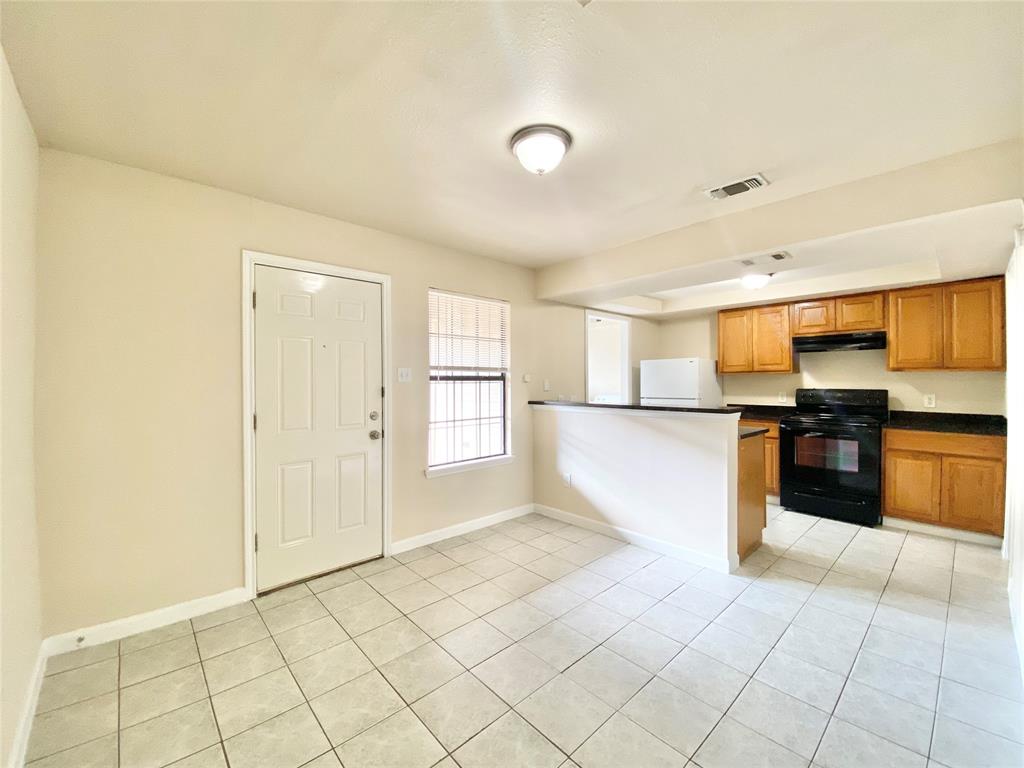 8001 C Rothington Road, Unit 21 Dallas, TX 75227 - Photo 8 of 32 a view of a kitchen with a sink and a refrigerator