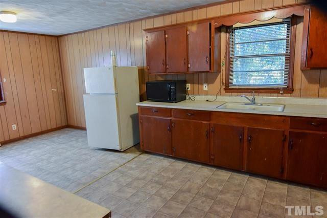 217 Lake Drive Roxboro, NC 27573 - Photo 4 of 20 a kitchen with stainless steel appliances granite countertop a refrigerator and a sink