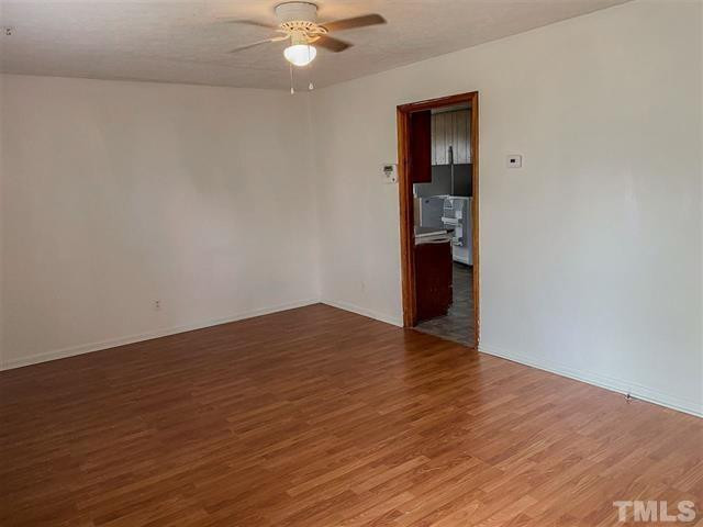 217 Lake Drive Roxboro, NC 27573 - Photo 9 of 20 a view of an empty room with wooden floor