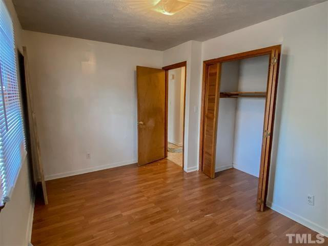 217 Lake Drive Roxboro, NC 27573 - Photo 10 of 20 a view of an empty room with wooden floor and a window