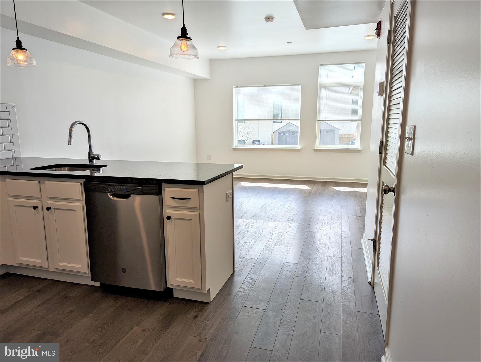 6615 Ridge Avenue, Unit 304 Philadelphia, PA 19128 - Photo 4 of 10 a kitchen with wooden floors and a sink