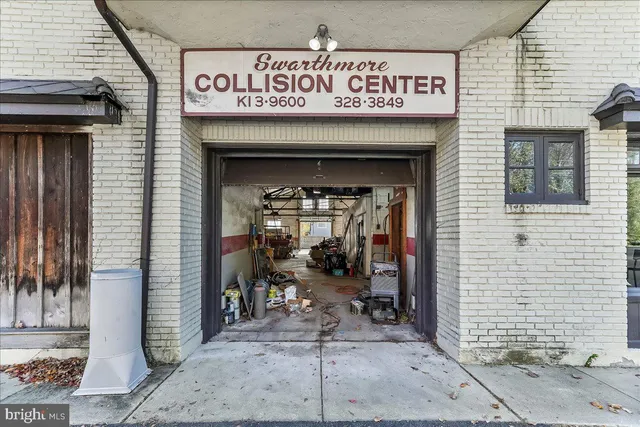 a view of a house with large windows and a small yard