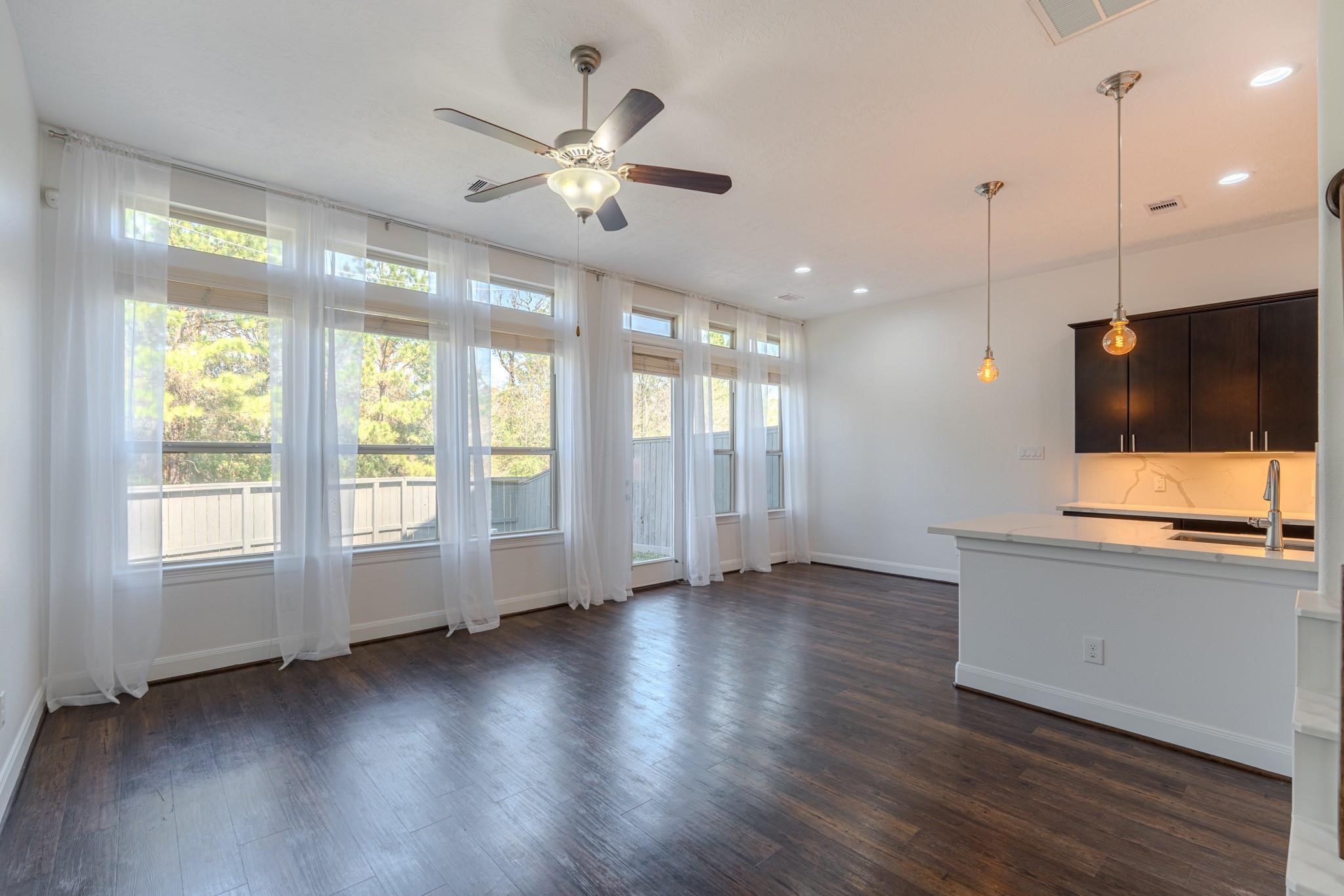 58 Aventura Place Spring, TX 77389 - Photo 13 of 23 a view of an empty room with wooden floor and a window