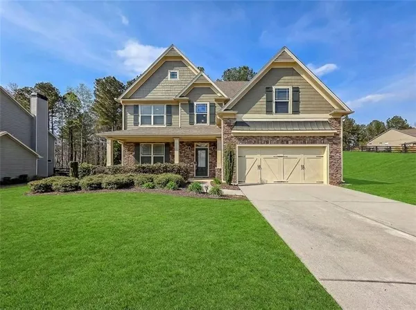 a front view of a house with a yard