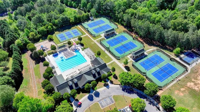 an aerial view of a house with a yard and pool