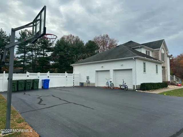 a white house that has a tree in front of it