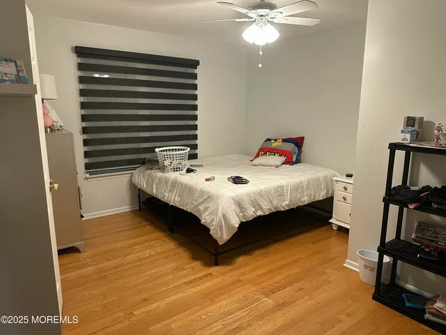 a bedroom with a bed and a flat tv screen on the dresser