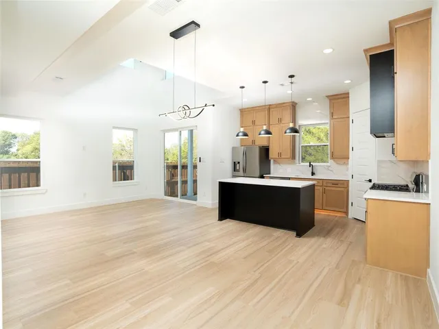 a large bathroom with a tub double sink and a mirror