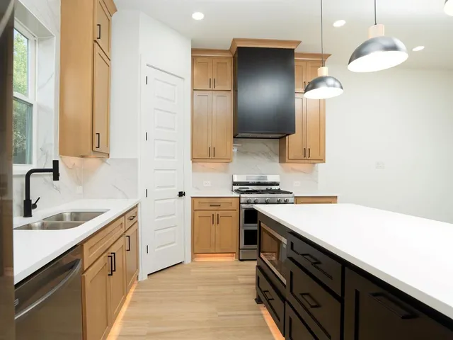 a kitchen with a sink stove and cabinets