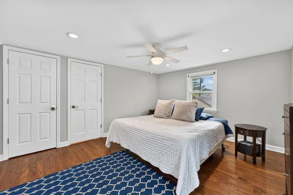 a bedroom with a bed and wooden floor