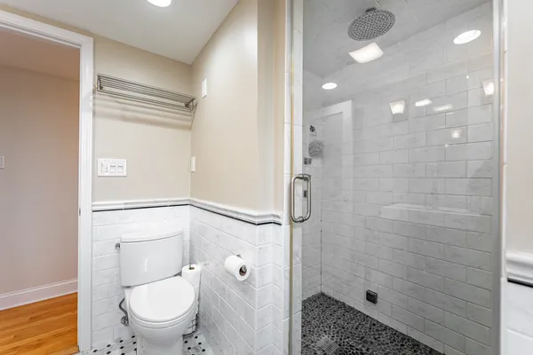 a bathroom with a granite countertop sink toilet and shower