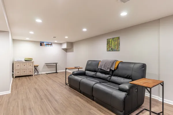 a living room with furniture and a wooden floor