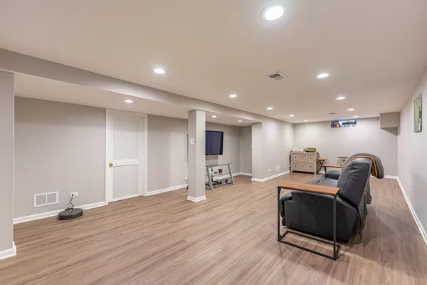 a living room with furniture and wooden floor