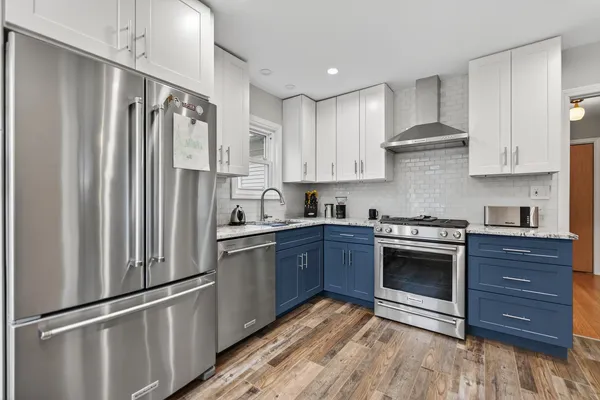 a kitchen with granite countertop stainless steel appliances and wooden cabinets