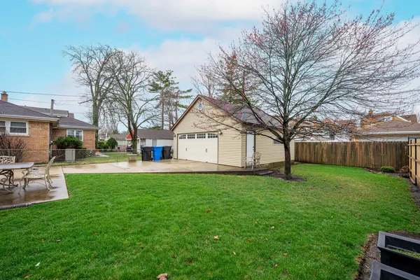 a view of a house with backyard and sitting area