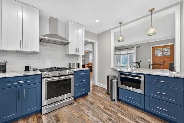 a kitchen with wooden cabinets and stainless steel appliances