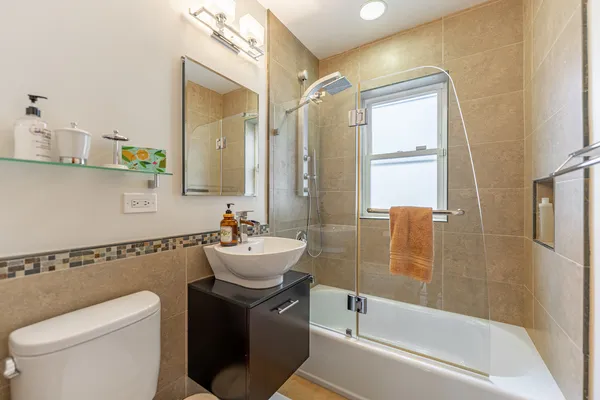 a bathroom with a granite countertop sink toilet and shower