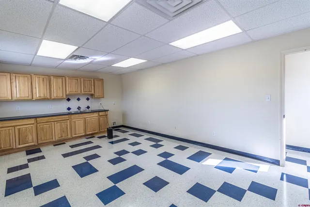 a kitchen with a checkered floor and a black white checkered floor