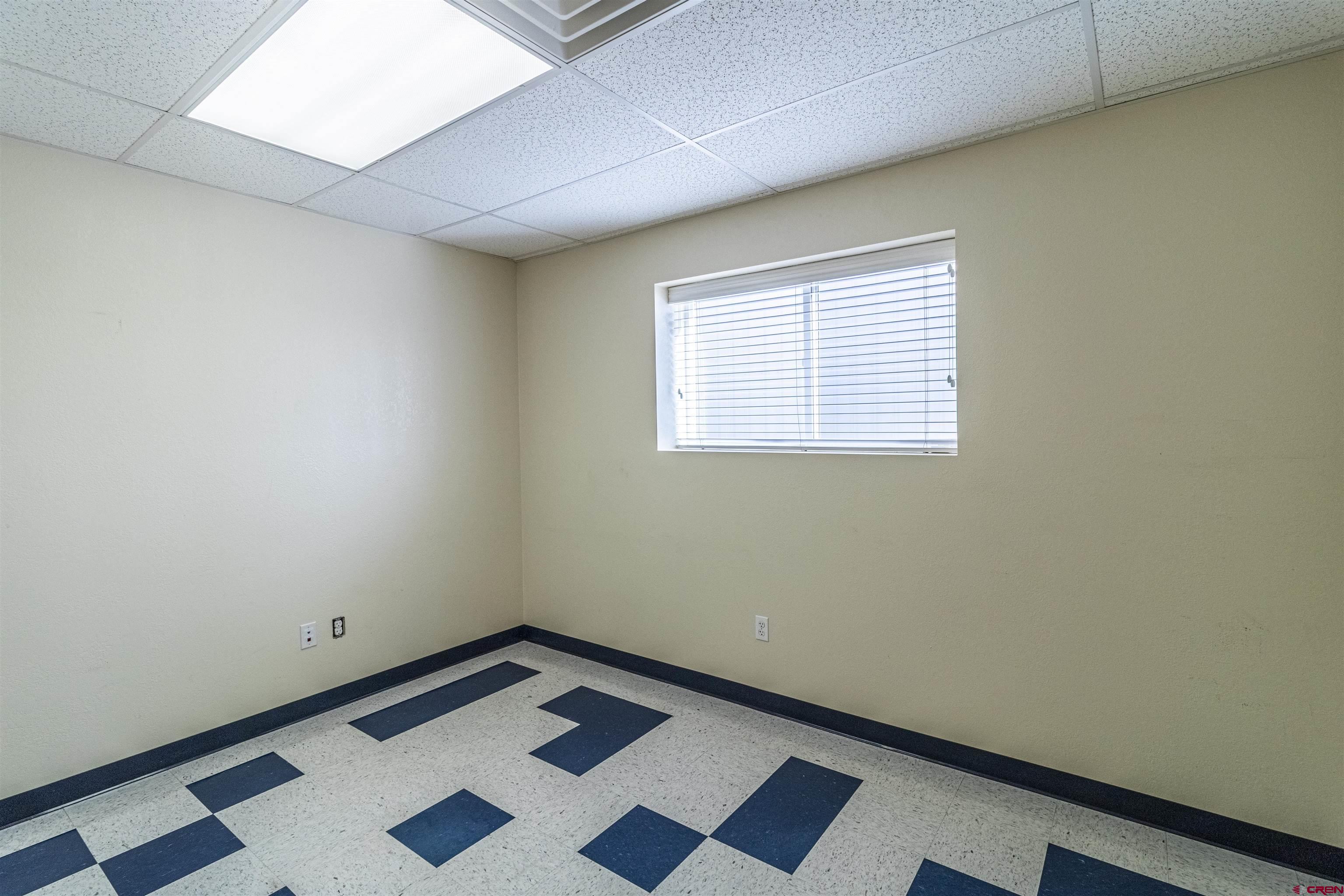 60 County Road 3961 Farmington, NM 87401 - Photo 15 of 35 a room with a black white checkered floor with a sink and a window