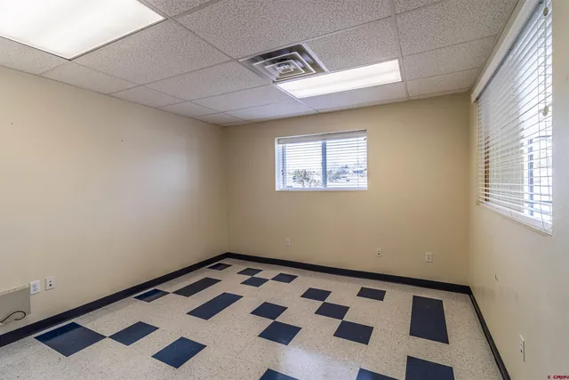 a view of a room with wooden floor and black walls