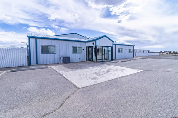 a big house with a big yard and large trees