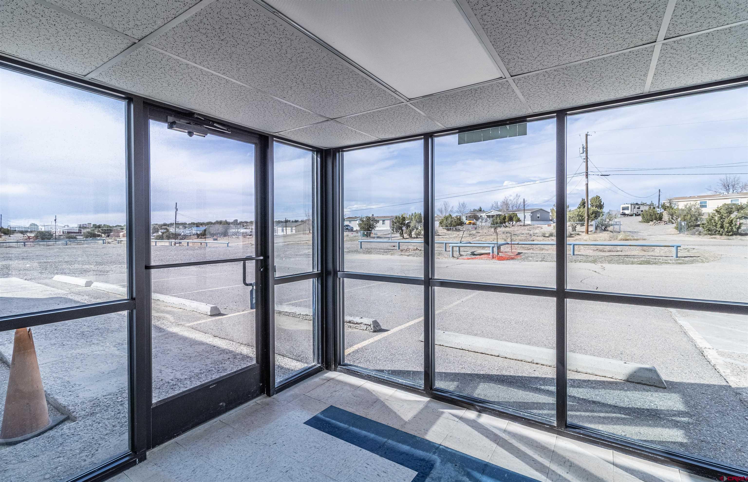 60 County Road 3961 Farmington, NM 87401 - Photo 8 of 35 a view of an empty room with wooden floor and windows