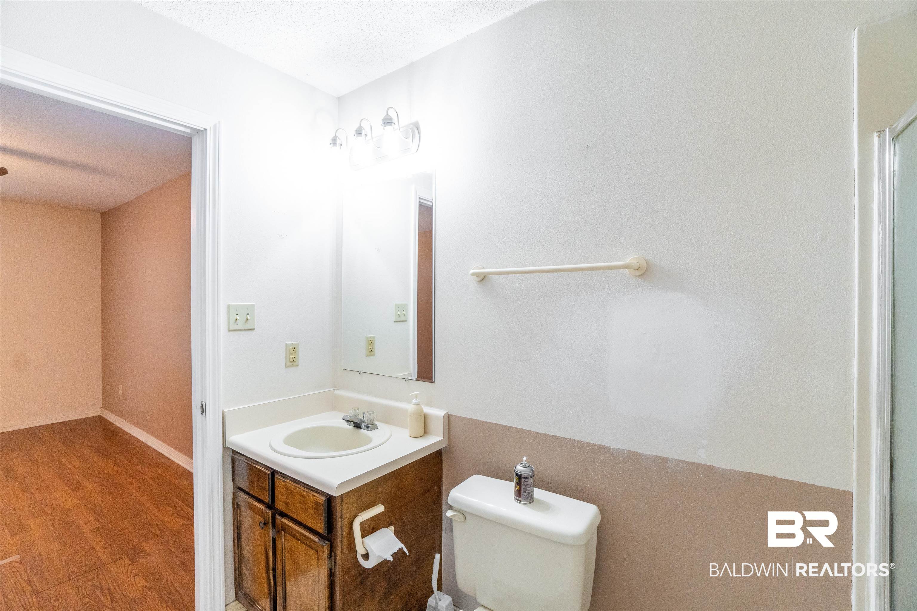 10349 Longview Drive West Foley, AL 36535 - Photo 25 of 35 Bathroom featuring vanity, toilet, a textured ceiling, and hardwood / wood-style floors