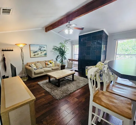 a living room with furniture and a chandelier
