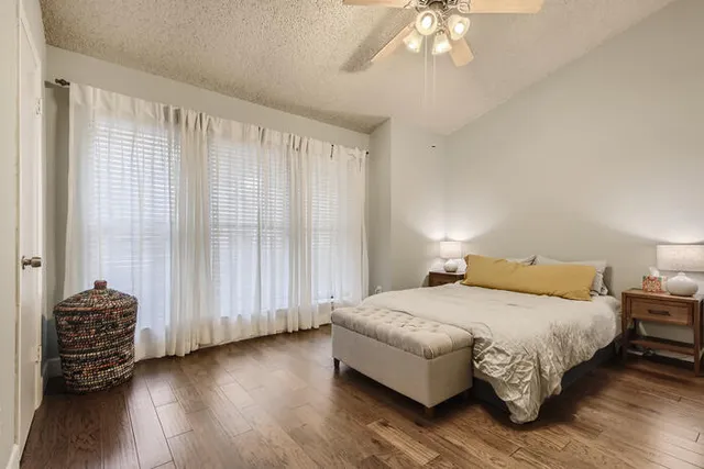 a bedroom with a bed and a chandelier