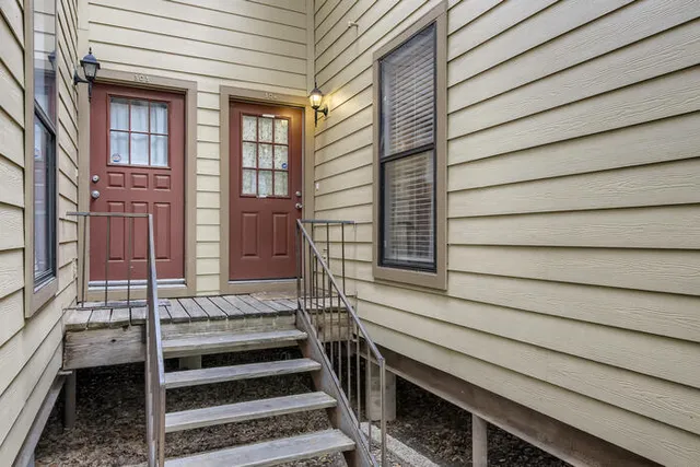 a view of a house with a door and wooden floor