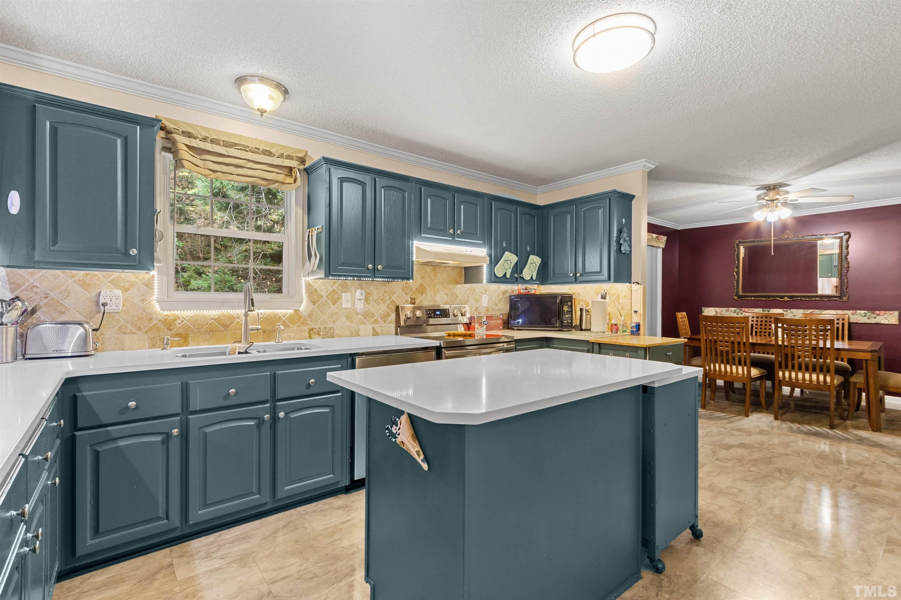 2710 Hurdover Road Apex, NC 27539 - Photo 12 of 52 a kitchen with a sink stove and cabinets