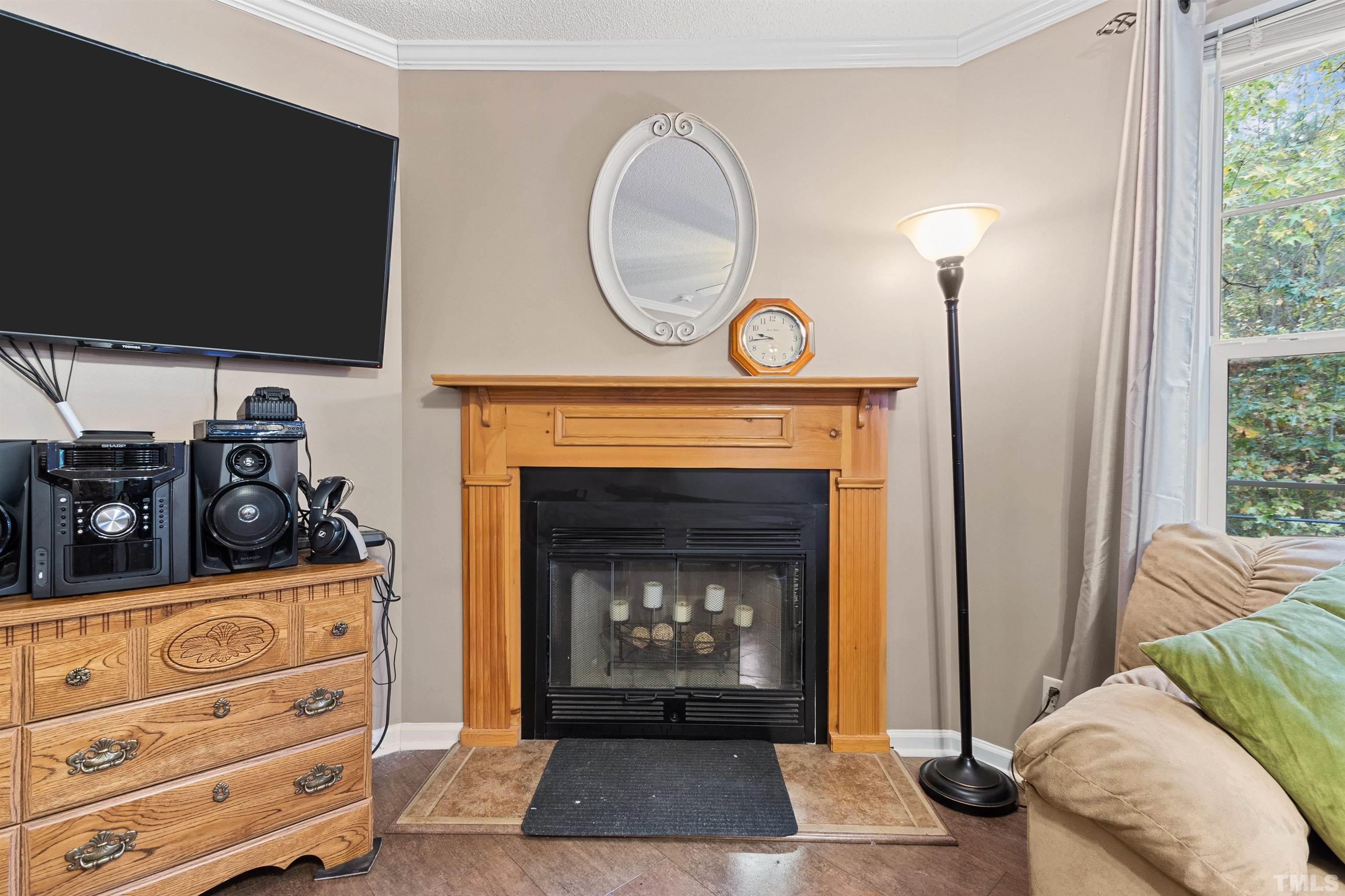 2710 Hurdover Road Apex, NC 27539 - Photo 17 of 52 a living room with furniture a flat screen tv and a fireplace