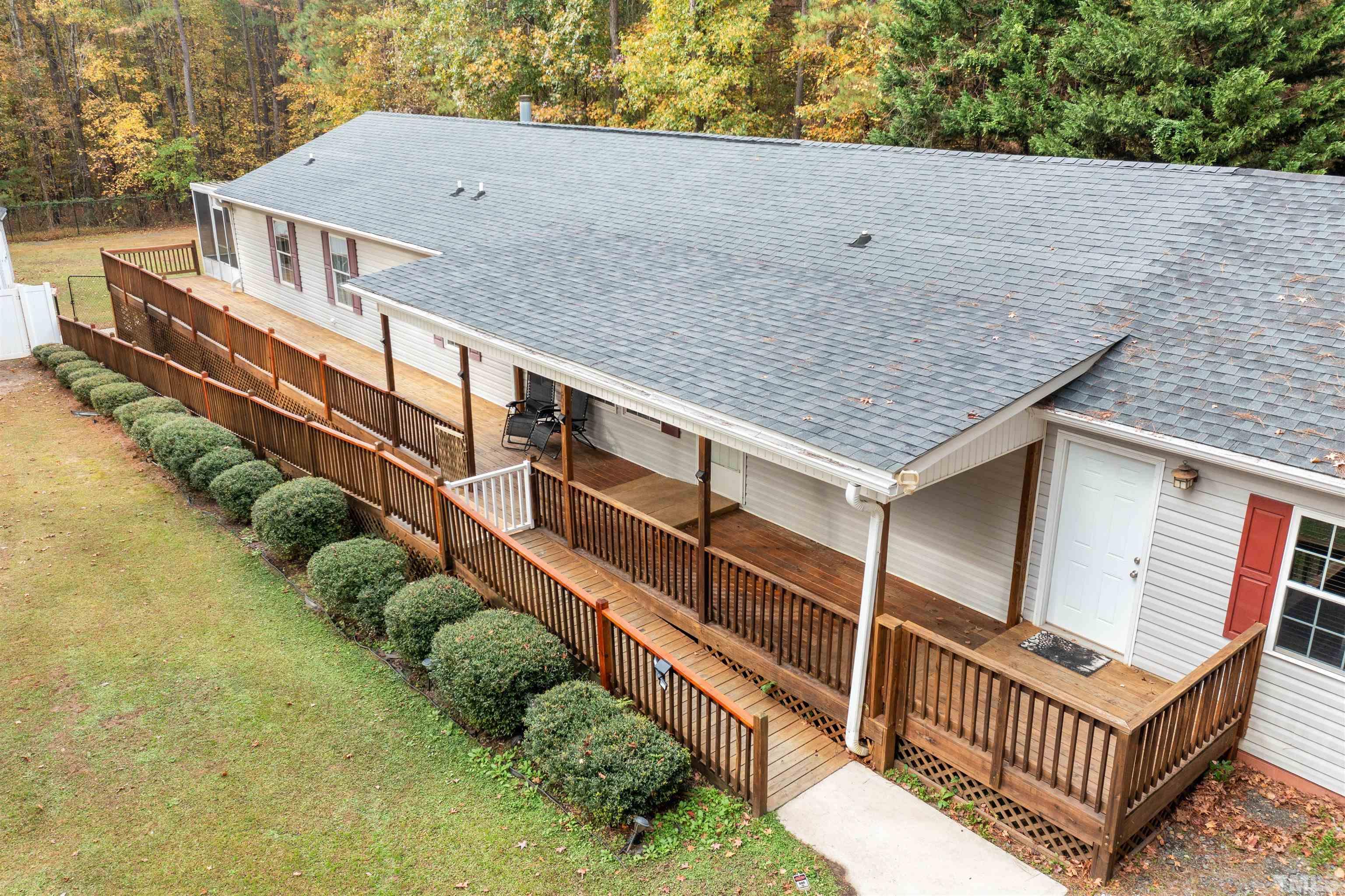 2710 Hurdover Road Apex, NC 27539 - Photo 2 of 52 an aerial view of a house with large trees and a wooden deck