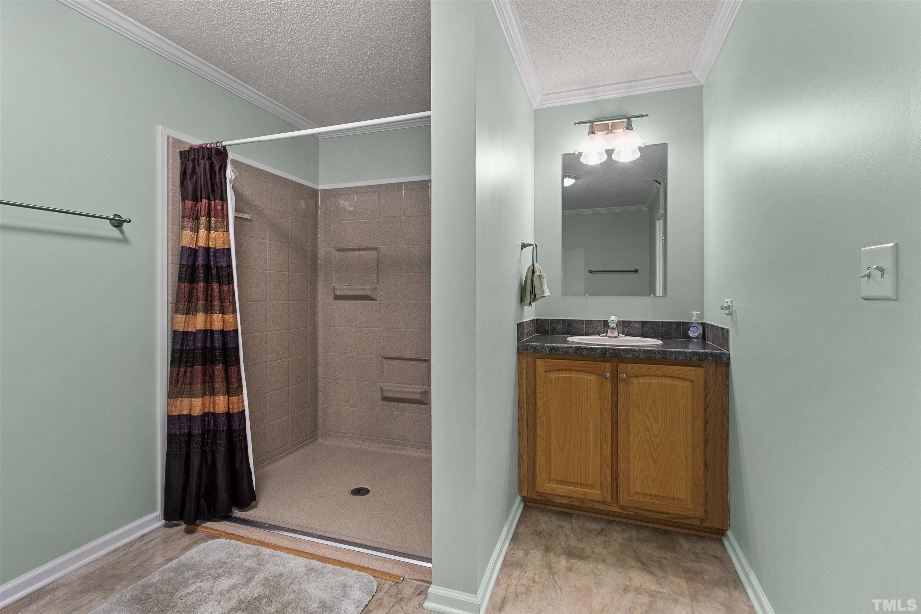 2710 Hurdover Road Apex, NC 27539 - Photo 27 of 52 a bathroom with a shower and a sink
