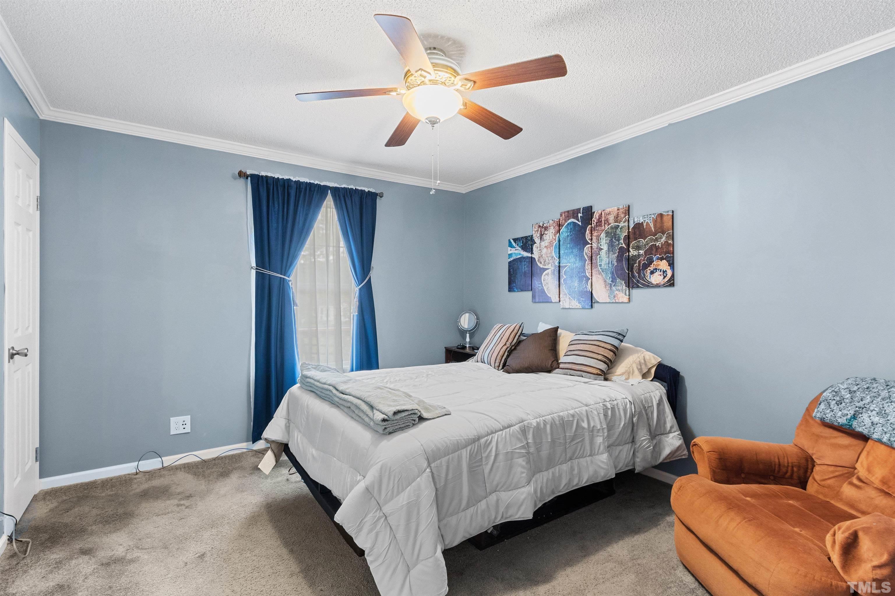 2710 Hurdover Road Apex, NC 27539 - Photo 28 of 52 a bedroom with bed and a chandelier