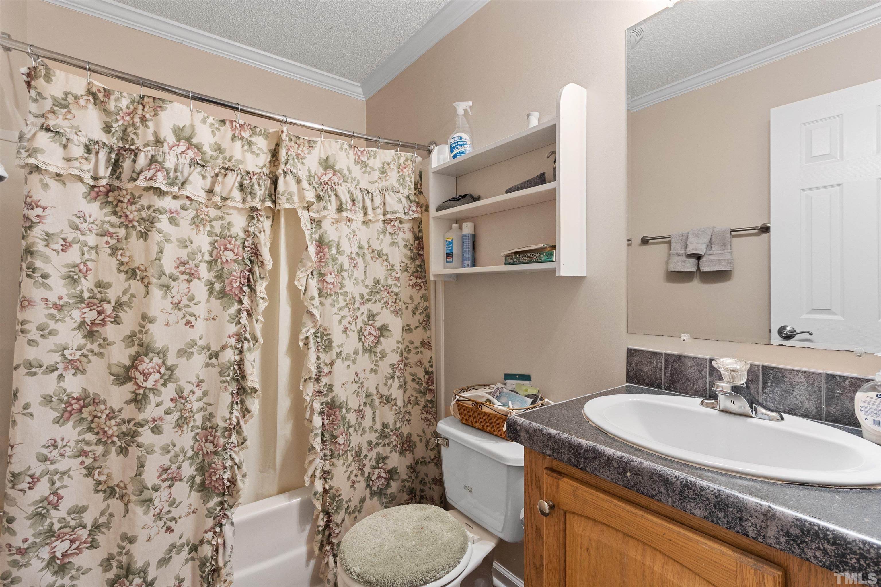 2710 Hurdover Road Apex, NC 27539 - Photo 29 of 52 a bathroom with a sink toilet and shower