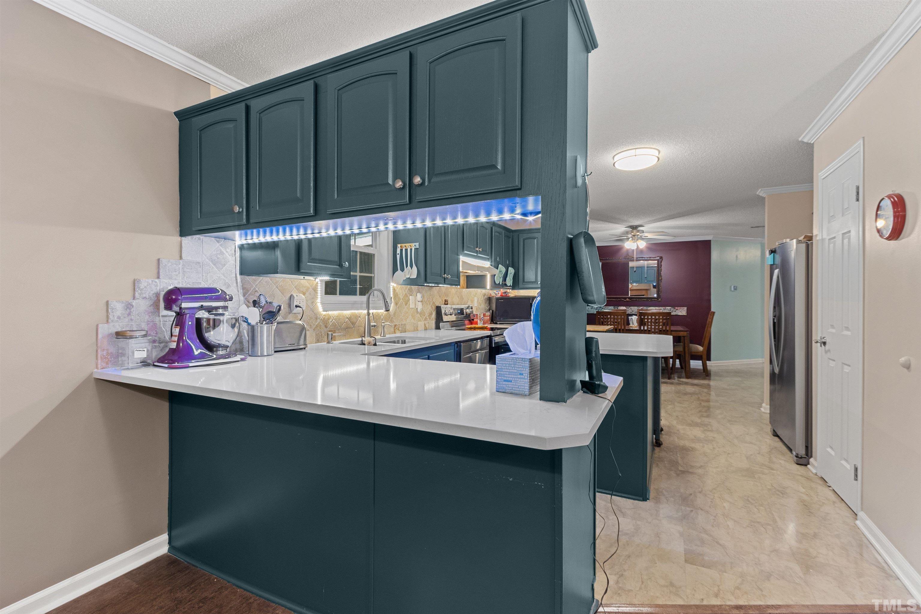 2710 Hurdover Road Apex, NC 27539 - Photo 10 of 52 a kitchen with a sink cabinets and utility