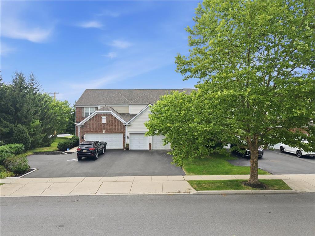 8761 Cascade Road Breinigsville, PA 18031 - Photo 1 of 84 Well-maintained townhome with attached garages and verdant landscaping.