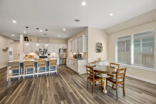 a dining room with furniture and wooden floor