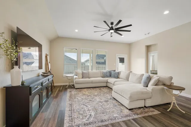 a living room with furniture and a large window