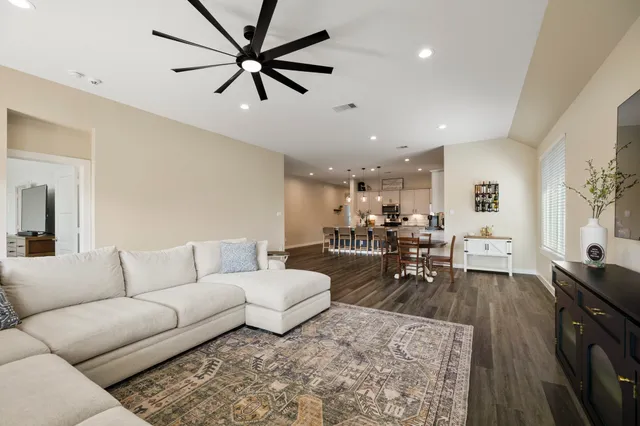 a living room with furniture and a chandelier