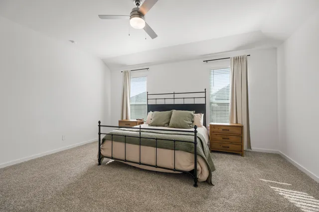 a bed sitting in a room next to a window