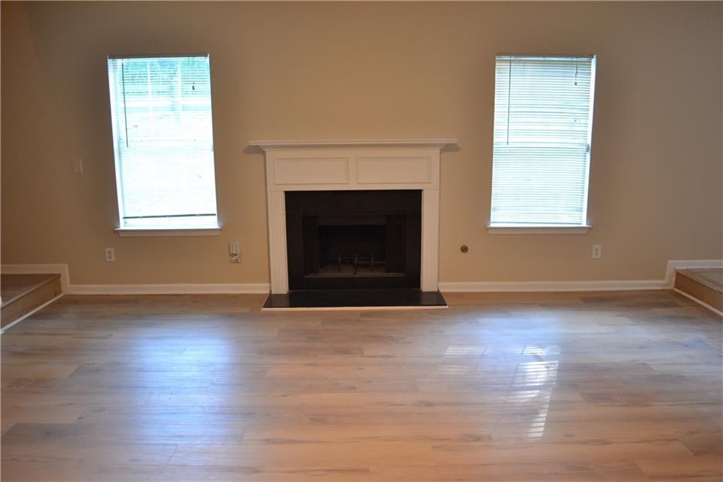 6157 Red Top Loop Union City, GA 30291 - Photo 12 of 26 a view of empty room with wooden floor and a fireplace